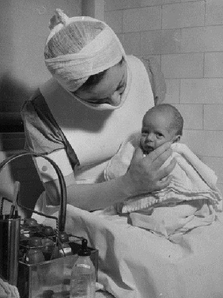Vintage photo of a nurse with a premature baby
