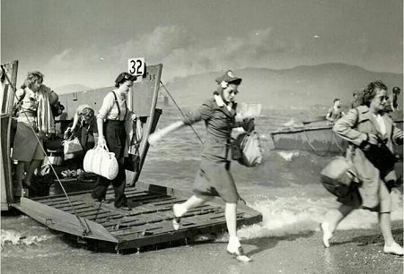 Wartime nurses getting out of the boat.
